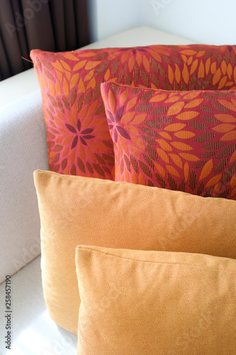 close up red and orange pillows on a sofa or couch in modern luxury style