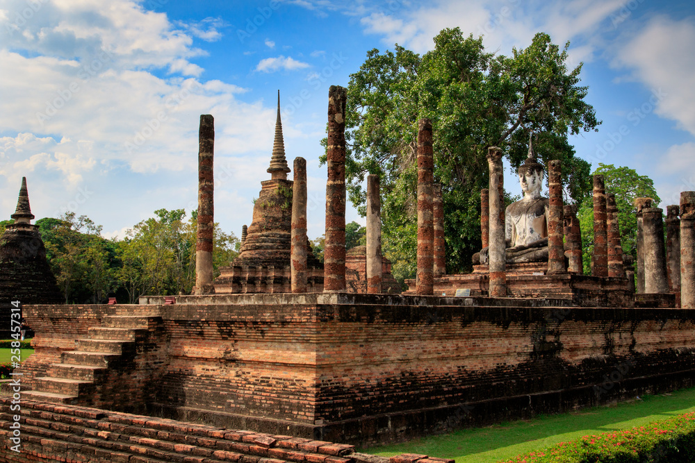 Obraz premium Pagoda and the buddha statue. in Old Buddhist temple in Sukhothai historical park In Thailand., Tourism, World Heritage Site, Civilization,UNESCO.