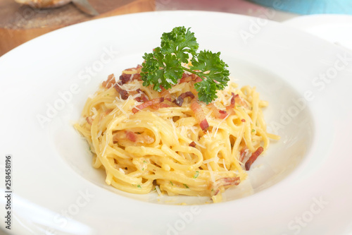 carbonara with bacon pasta on top with cheese and parsley