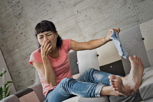 woman holding dirty sock