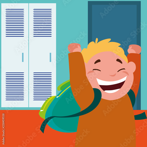 little schoolboy with schoolbag in school corridor