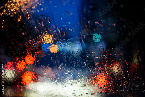Blurred background of traffic and car lights in rain at night