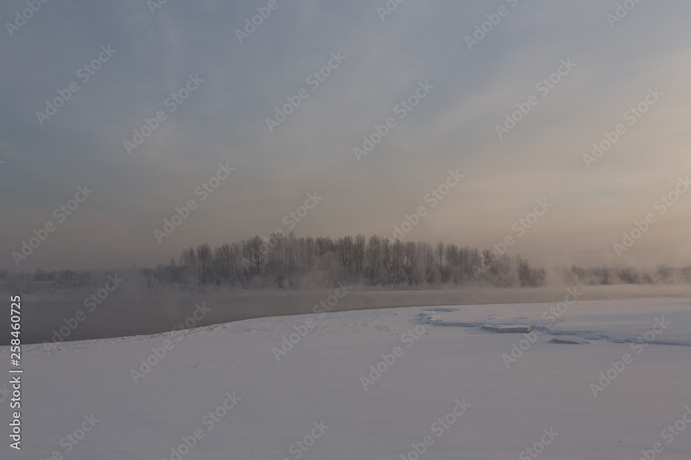winter frosty sunset on the river in Siberia in winter winter frosty sunset on the river in Siberia in winter
