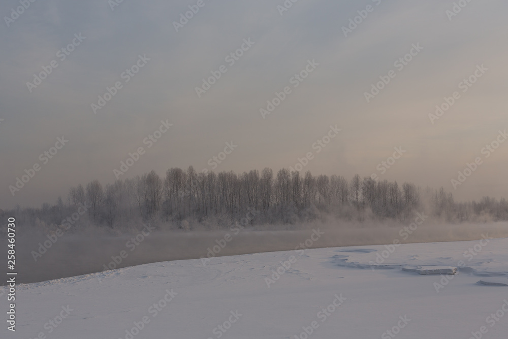 winter frosty sunset on the river in Siberia in winter winter frosty sunset on the river in Siberia in winter