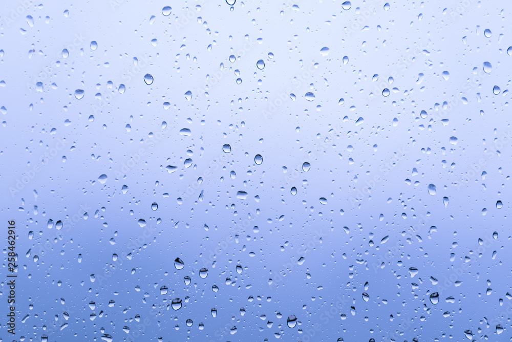 Close up raindrops on the window with blur background Close up raindrops on the window with blur background