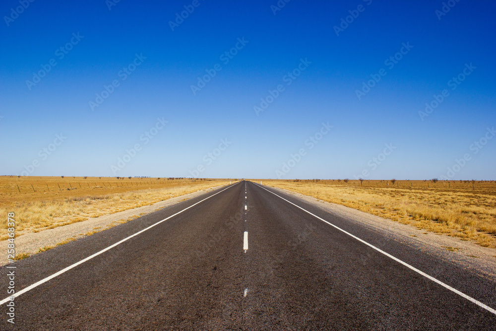 traight road in the dessert of Australia on the Flinders Hightway, Quennsland Australia