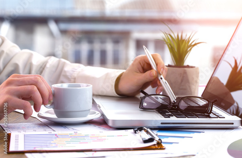 Women's hands with items for business on the table