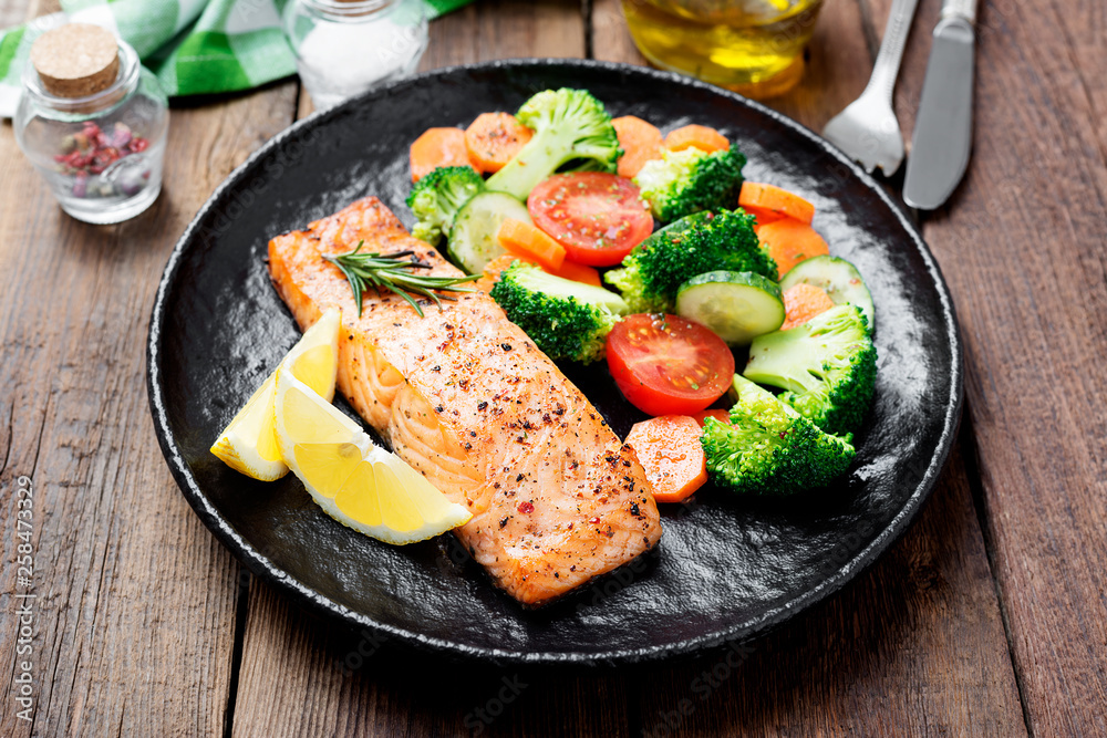 Baked salmon fillet with broccoli and vegetables mix.