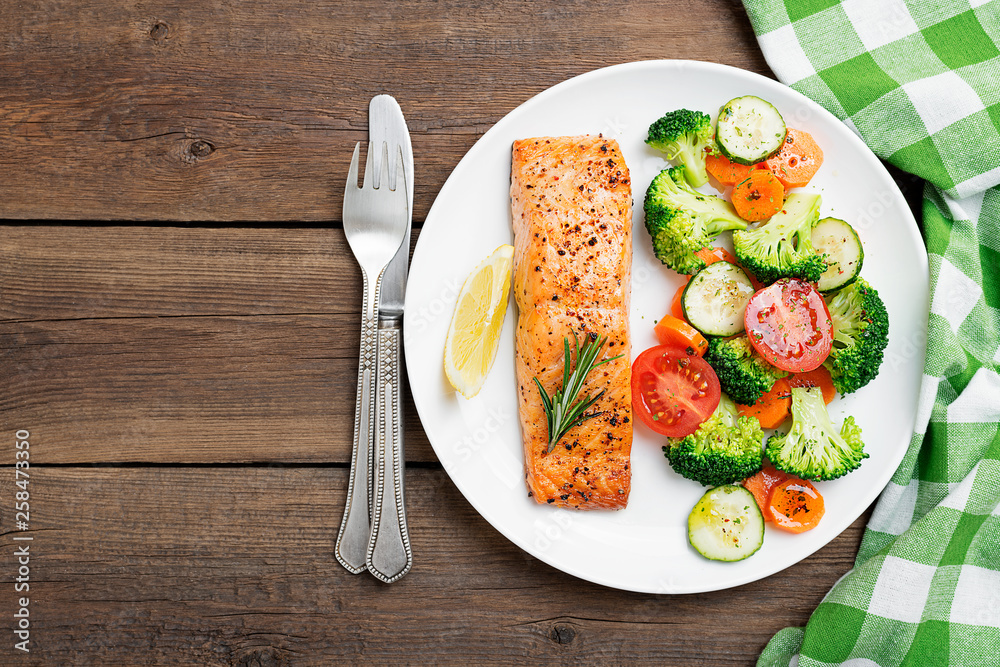 Baked salmon fillet with broccoli and vegetables mix. Baked salmon fillet with broccoli and vegetables mix.