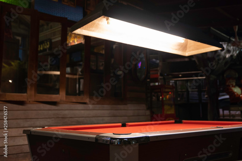 Vintage pool table in night club, pool snooker billiard concept background.