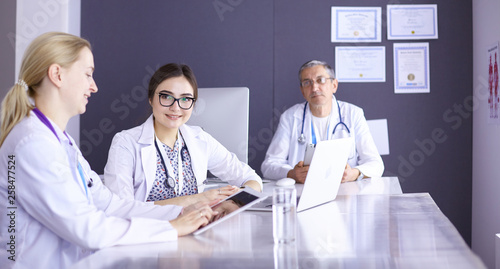 Doctors having a medical discussion in a meeting room © lenetsnikolai