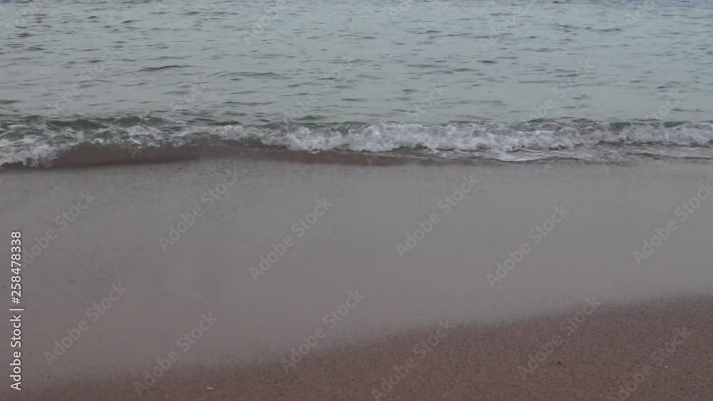 Waves on a sandy beach after sunset Waves on a sandy beach after sunset