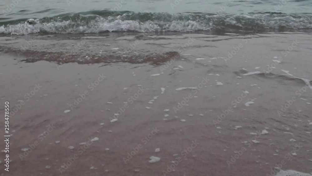 Waves on a sandy beach after sunset Waves on a sandy beach after sunset