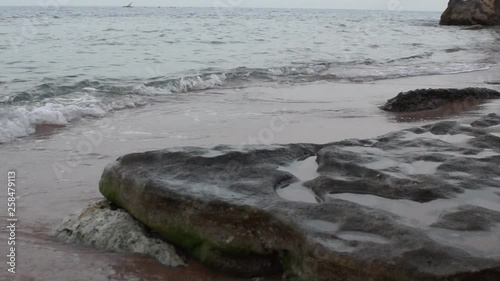 Waves on a sandy beach after sunset