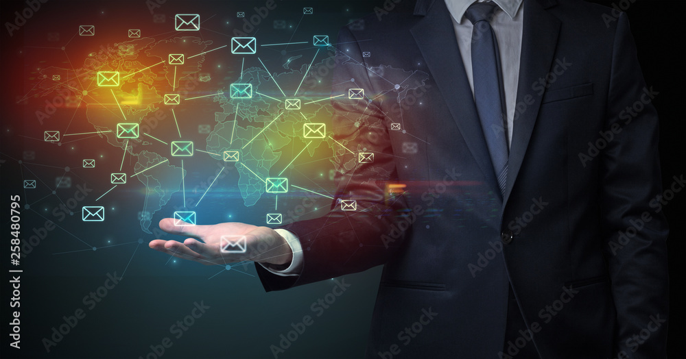 Obraz premium Elegant businessman holding communication concept on his hand 