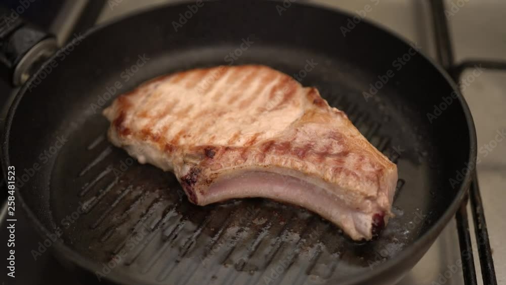 Pork steak is fried in a pan. Pork steak is fried in a pan.