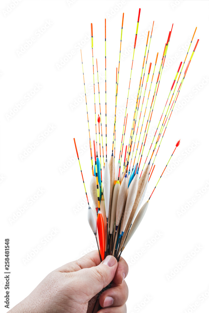 many different floats in size, length, color in hand isolated on white