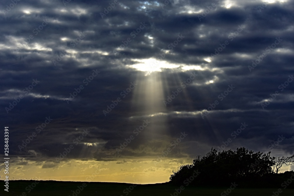 Sun beaming through cloud opening background Sun beaming through cloud opening background