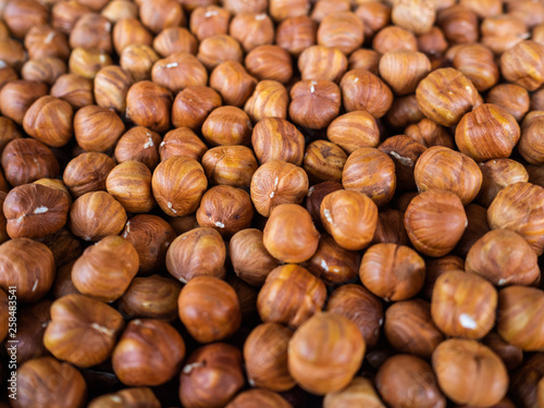 The peeled hazelnut. It is a lot of filbert on a counter of shop. Useful, nutritious product