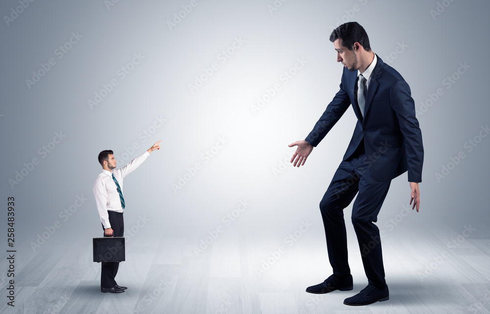 Small businessman in shirt pointing to an afraid businessman
Small businessman in shirt pointing to an afraid businessman