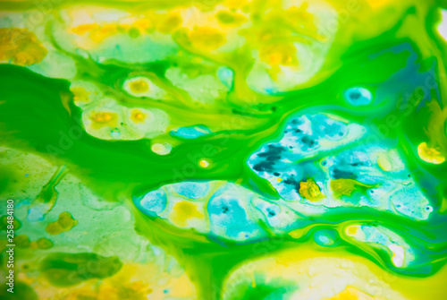 Fluid art watercolor party background. Cosmic music poster. Creative artwork hippie wallpaper in yellow green blue color.