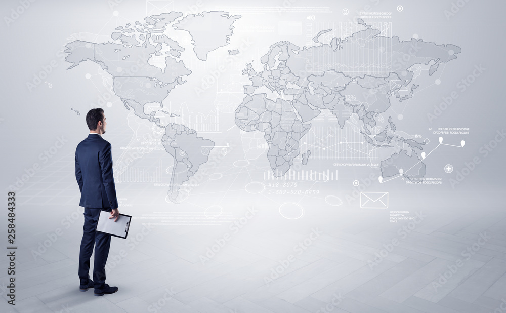 Businessman standing with his back and looking at a worldwide map with objects in his hand
Businessman standing with his back and looking at a worldwide map with objects in his hand