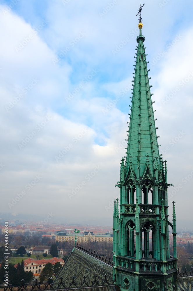 Tower of Gothic St. Vitus Cathedral on background of city, Prague, Czech Republic Tower of Gothic St. Vitus Cathedral on background of city, Prague, Czech Republic