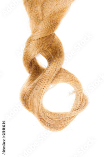 Long beautiful blond hair in shape of numeral eight, isolated on white background