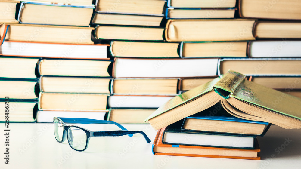Books background, open book and glasses on white wooden table in office business background for education learning concept. Books background, open book and glasses on white wooden table in office business background for education learning concept.