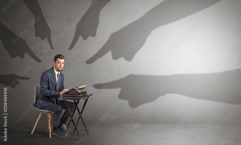 Shadow hand pointing at a small afraid worker
Shadow hand pointing at a small afraid worker