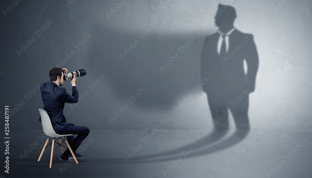 Humble businessman staying and offering stuffs to a huge angry bull shadow
Humble businessman staying and offering stuffs to a huge angry bull shadow