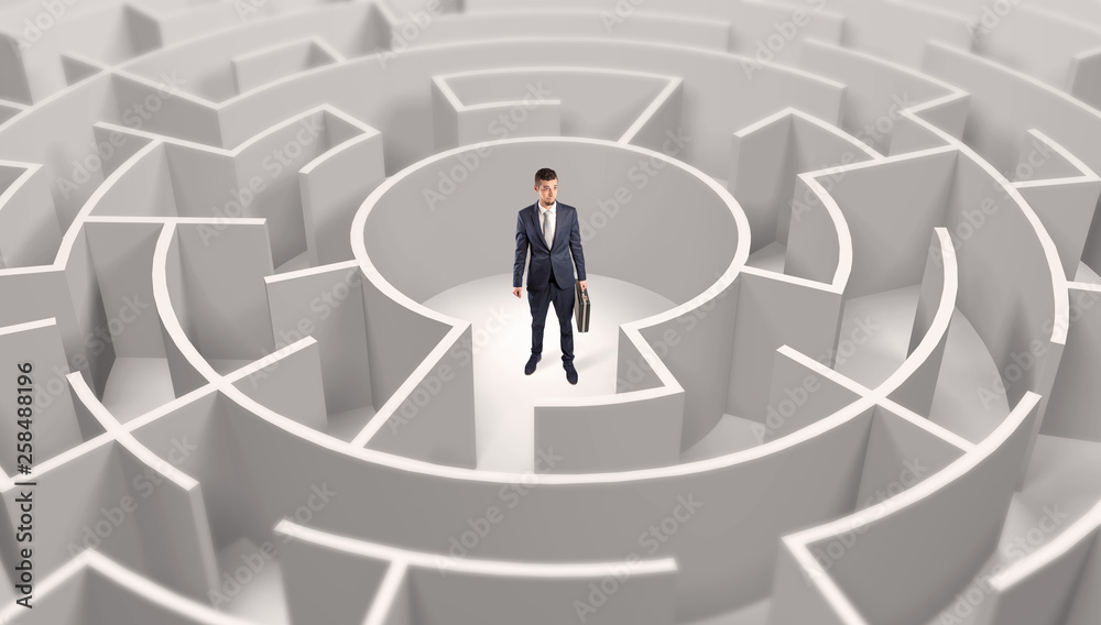 Young businessman standing in a middle of a 3d round maze
Young businessman standing in a middle of a 3d round maze