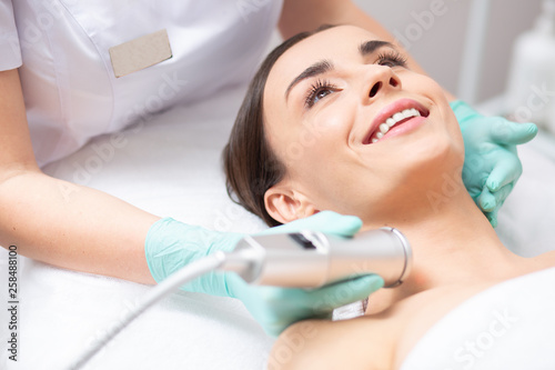 Close up of the face of happy lady during oxygen meso therapy