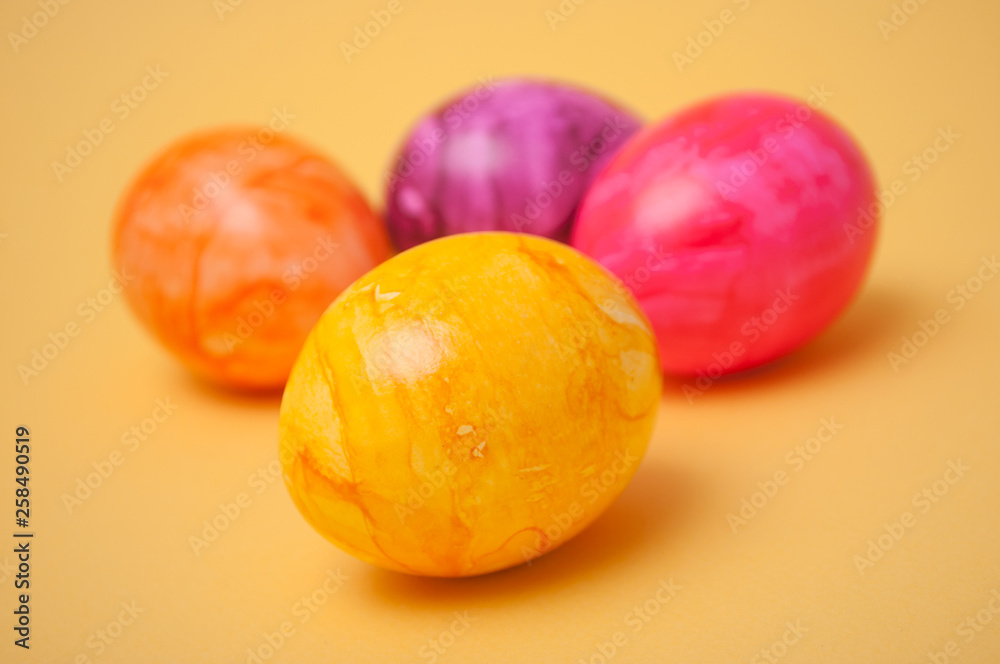 closeup of decorative painted easter eggs on yellow background closeup of decorative painted easter eggs on yellow background
