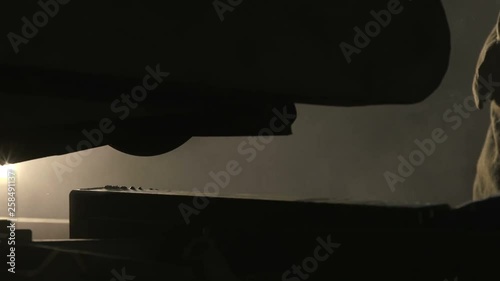 Huge flat metallic plate put on machine tool in a dark workshop full of spakles
