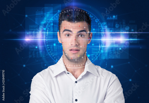 Facial recognition system. Young man on blue background