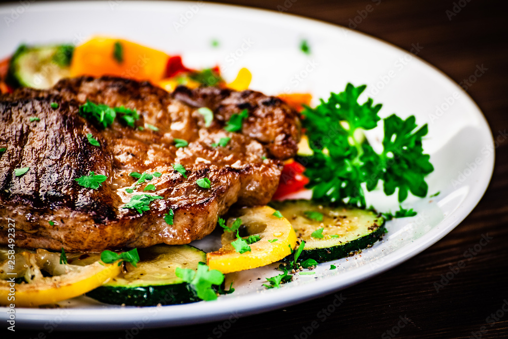 Grilled steak with potatoes and vegetable salad Grilled steak with potatoes and vegetable salad