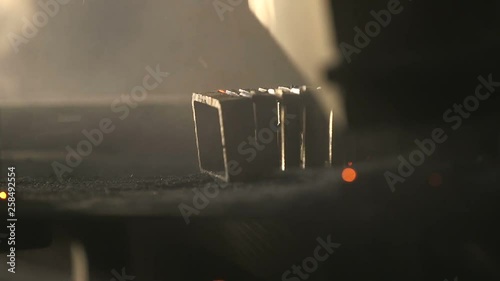 Plazma looking stream of yellow sparkles over a mashine tool in a workshop