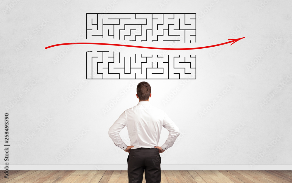 Businessman in doubt looking to a maze and searching the way out Businessman in doubt looking to a maze and searching the way out