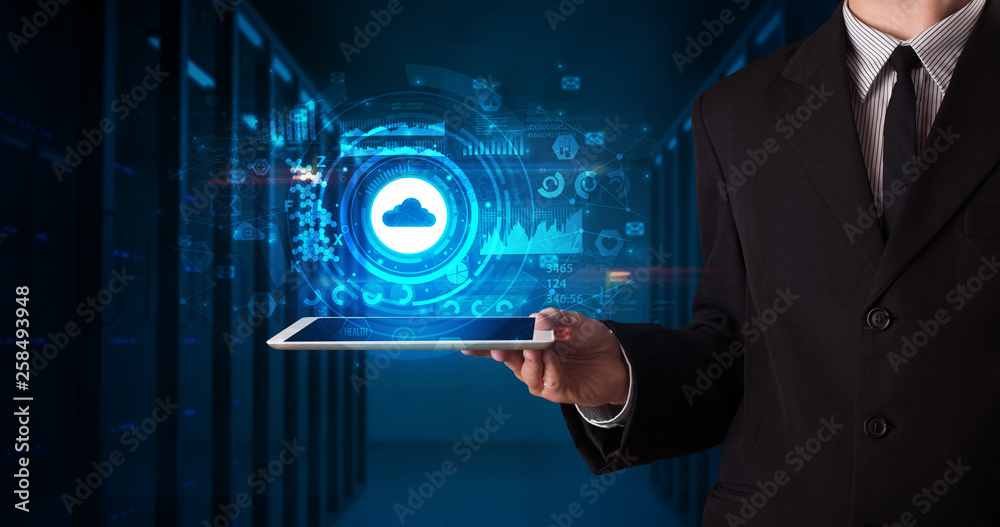 © ra2 studio - Hand holding tablet with cloud technology and dark concept