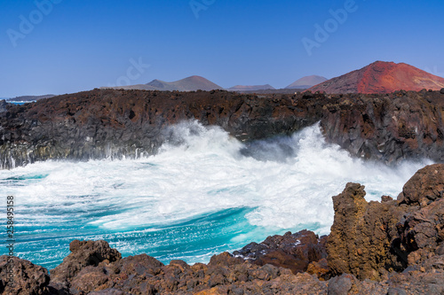 Spain, Lanzarote, Amazing huge waves breaking in tourism destination los hervideros bay © Simon