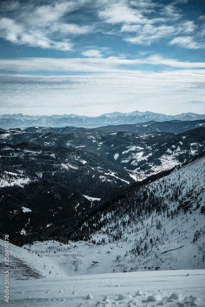 View of a valley in Austrian Alps. Photographed from slope in Turracher Hoehe in February. Winter wonderland.