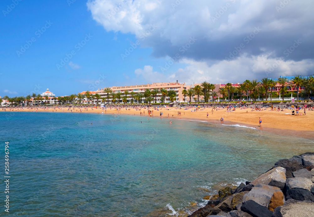 Beautiful coastal view of Playa del Camison beach with turquoise water and yellow sand in Las Americas, Tenerife,Canary Islands,Spain.Travel or vacation concept.