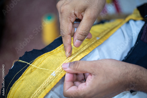 A tailor preparing the final touches of a bisht, a men’s clothing in Qatar photo