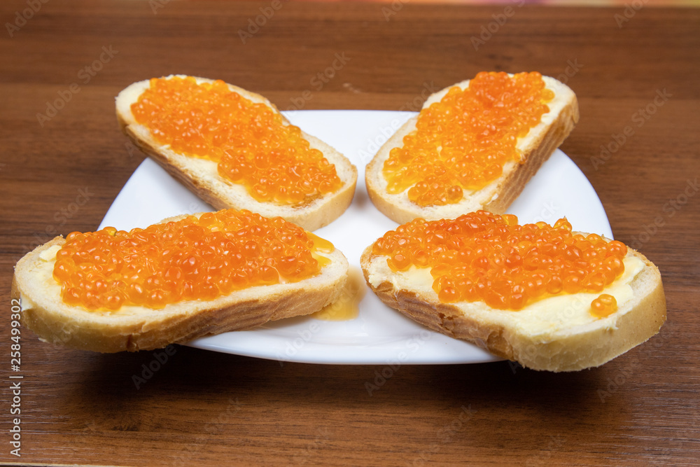 Sandwiches with butter and red caviar on a plate Sandwiches with butter and red caviar on a plate