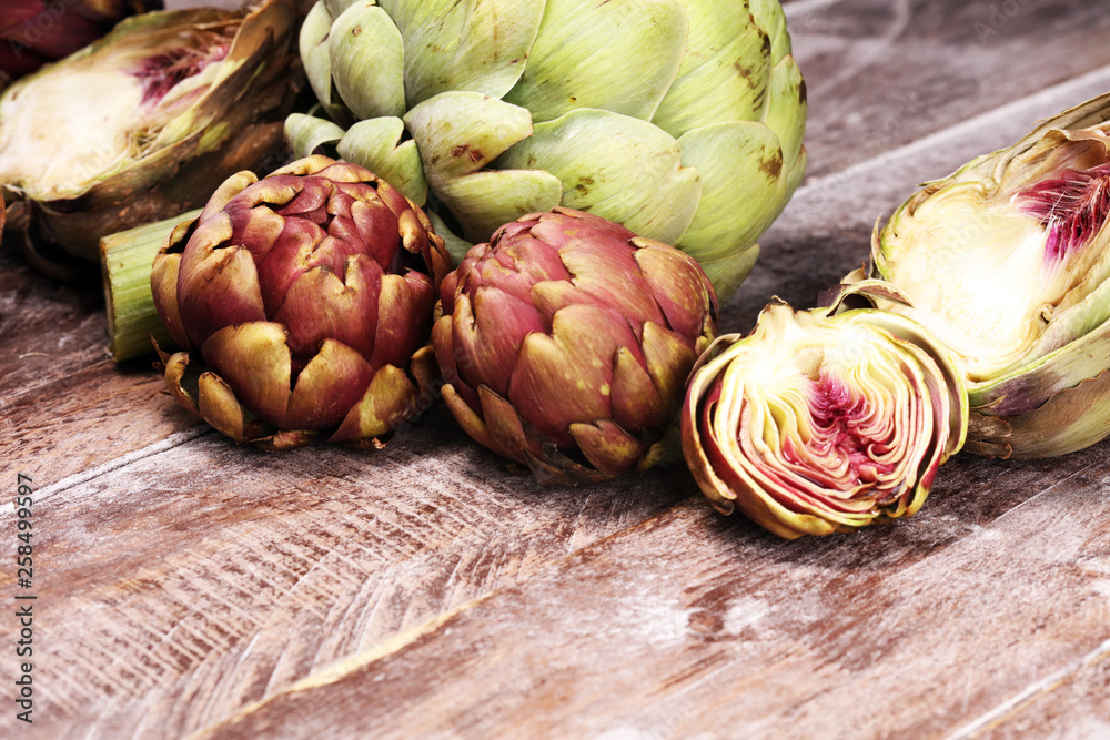 Obraz premium artichokes on grey background. fresh organic artichoke flower vegetable