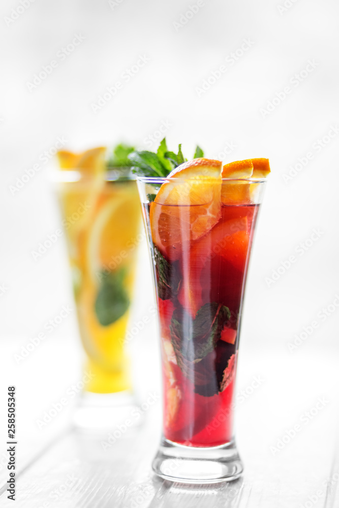 Refreshing healthy drinks with mint and citrus and pomegranate on a white background.Refreshing cold cocktails with mint and citrus and pomegranate on a white background. Concept for drinks, summer Refreshing healthy drinks with mint and citrus and pomegranate on a white background.Refreshing cold cocktails with mint and citrus and pomegranate on a white background. Concept for drinks, summer