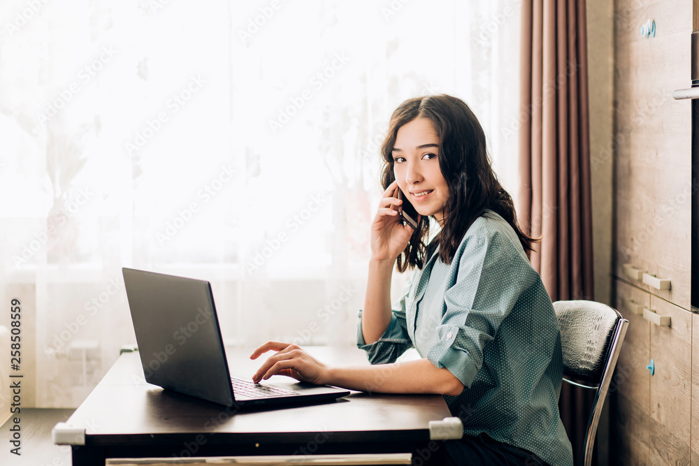 Happy young woman using laptop at home Happy young woman using laptop at home