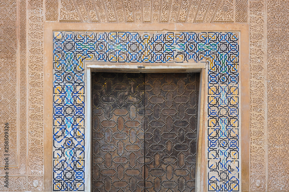 Door decorated with typical arab patterns in the Nasrid Palaces of the Alhambra in Granada, Spain