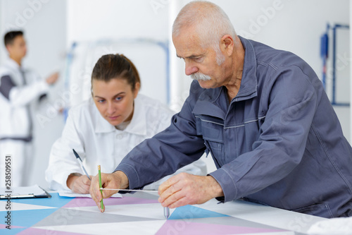 senior man and younger woman at art school